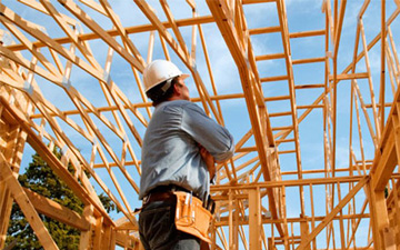 A man standing in front of a building under construction.