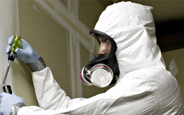 A person in white suit and gas mask