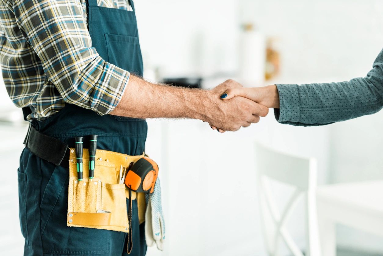 Two men shaking hands in a room.